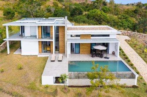 an aerial view of a house with a swimming pool at PASSOT HILLS in Nosy Be