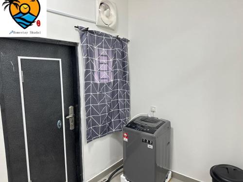 a room with a door with a picture on the wall at ZZZ HOMESTAY SKUDAI in Skudai