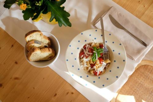 a table with a plate of food and a bowl of food at Masseria Grieco in Ostuni