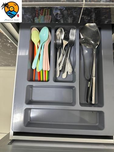 a plastic tray with utensils in a drawer at ZZZ HOMESTAY SKUDAI in Skudai