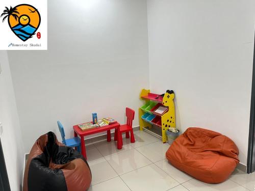 a childs play room with a table and a stool at ZZZ HOMESTAY SKUDAI in Skudai