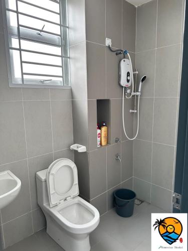 a bathroom with a shower and a toilet and a sink at ZZZ HOMESTAY SKUDAI in Skudai