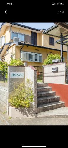 a set of stairs in front of a building at Bonel Guest House in Tomisato