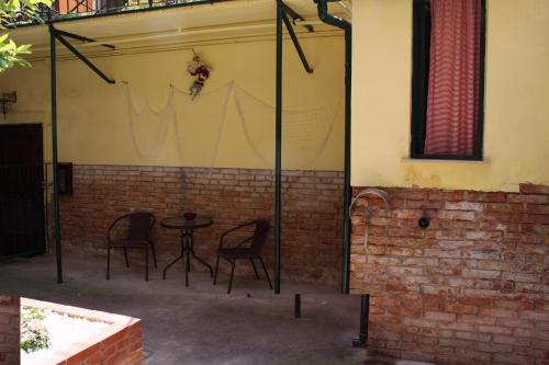 a patio with a table and chairs in a building at San Giacomo Apartment in Venice