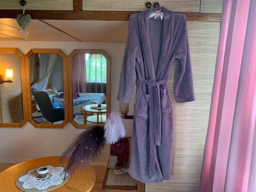 a robe hanging on the wall of a bedroom at Villa Mariett in Kuressaare