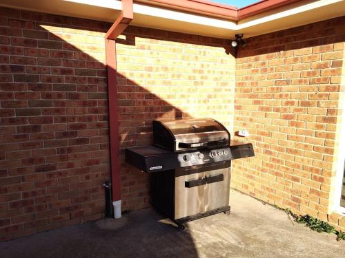 a brick wall with a grill and a toaster oven at Country Paradise Estate in Hall