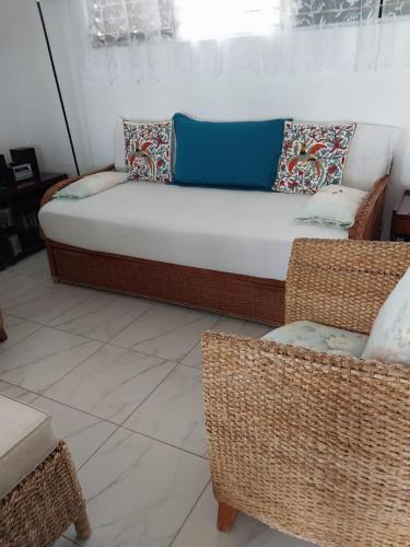 a couch and a chair in a living room at Swimming Pool- Balcony Veranda- Sea & Sunset Views in Dickenson Bay