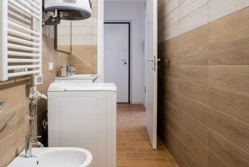 a bathroom with a sink and a toilet and a mirror at Vera Project Apartment in Milan