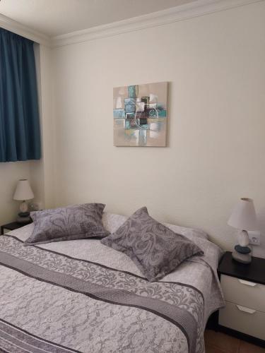 a bedroom with a bed with two pillows on it at Club La Mar 62 in Puerto de Santiago