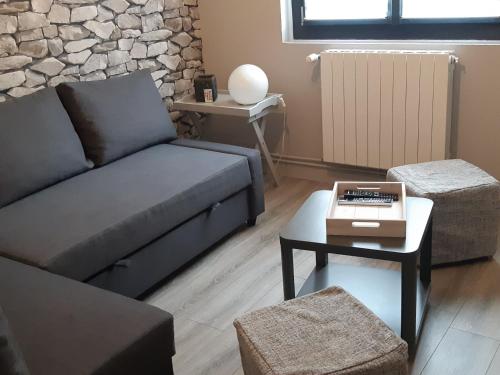 a living room with a couch and a table at La Maison de Jeanne in Capvern