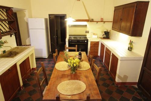 a kitchen with a wooden table with flowers on it at Palazzo Di Piero in Sarteano