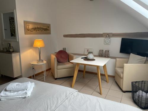 a room with a bed and a table and a couch at Weberhof Apartment 5 in Münster