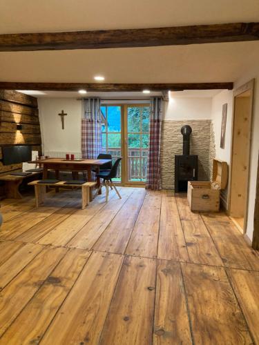 a living room with a table and a cross on the wall at Bandltroga in Murau