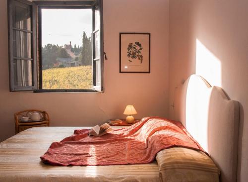 a bedroom with a bed with a blanket on it at Palazzo Di Piero in Sarteano