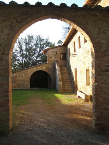 an archway in a brick building with a staircase at Palazzo Di Piero in Sarteano