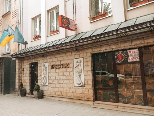 a facade of a pizza shop on a street at Prestige in Lviv