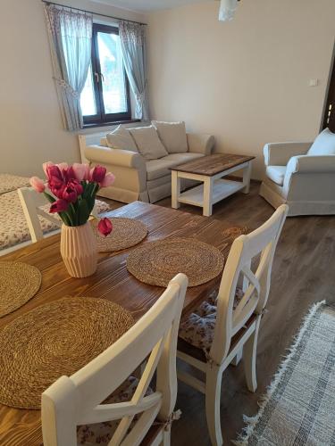 a living room with a table and chairs and a couch at Penzión Thamasy in Spišské Tomášovce