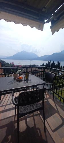a table and chairs on a patio with a view of the ocean at Casa Anita in Bellano