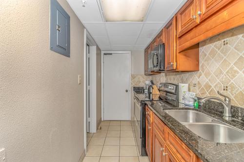a kitchen with a sink and wooden cabinets at Landmark 1134 in Myrtle Beach