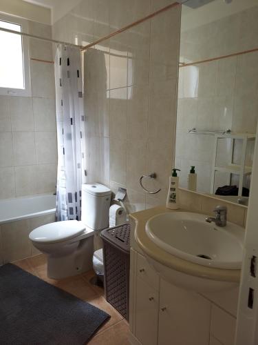 a bathroom with a toilet and a sink and a tub at Club La Mar 62 in Puerto de Santiago