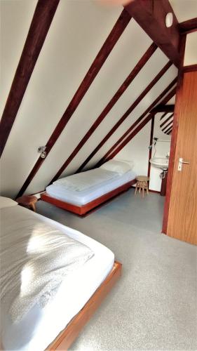 a bedroom with two beds in a attic at Ferienhaus Laange in Frankenau