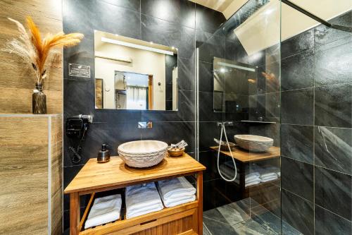 a bathroom with a sink and a shower at Le Prestige* * * * - Minibar Gratuit - Parking in Saint-Pierre