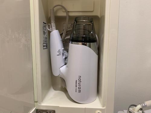 a white blender and a mixer in a cabinet at O2 capsule house OTARU in Otaru
