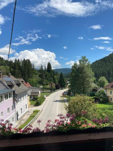 a street in a small town with flowers at Moserwirt Pension in Sankt Veit an der Glan
