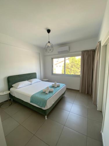 a bedroom with a bed and a large window at Anastasia 1 Bedroom Apartment in Limassol