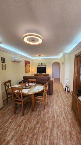 a living room with a table and a couch at La Manga del Mar Menor Los Miradores block 1 5th floor G in Murcia