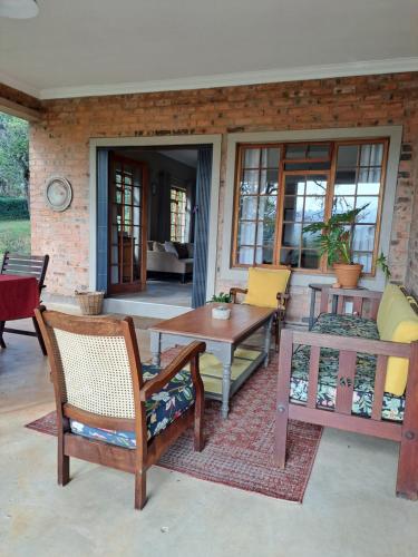 a patio with a table and chairs on a patio at Elvandar Country Cottage in Hilton