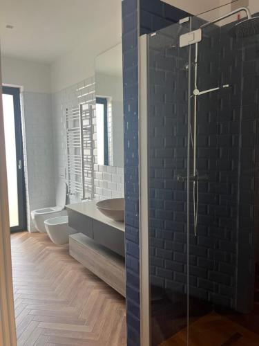 a bathroom with two toilets and a sink and a shower at Il primo sasso in Matera