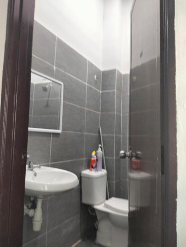 a bathroom with a toilet and a sink at D'Sara Homestay Fully Furnished 3 bedrooms All Aircond 2 miles centre in Kemaman