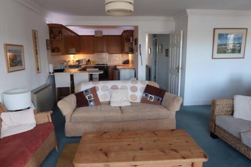 a living room with a couch and a table at Obsidian: Arguably the best view in Portballintrae in Portballintrae