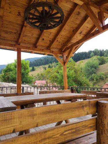 a wooden pavilion with a bench and a chandelier at Villa Kristina - Apartment no.2 in Vrben