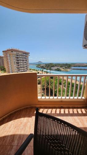 a bench sitting on a balcony with a view of the ocean at La Manga del Mar Menor Los Miradores block 1 5th floor G in Murcia