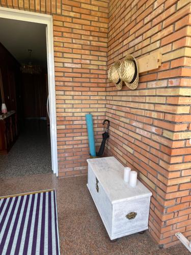 eine Ziegelwand mit einem Tisch und einem Baseballhandschuh in der Unterkunft Casa da Poza in Redondela