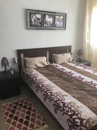 a bedroom with two beds and a picture on the wall at Bouganvilla in Adeje