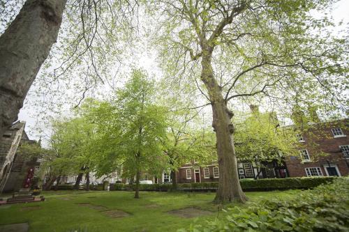 a park with trees in front of a building at The Lion Hotel Shrewsbury in Shrewsbury