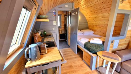 a small room with a bed in a tiny house at Bothan Creag Sobhrag in Ballachulish