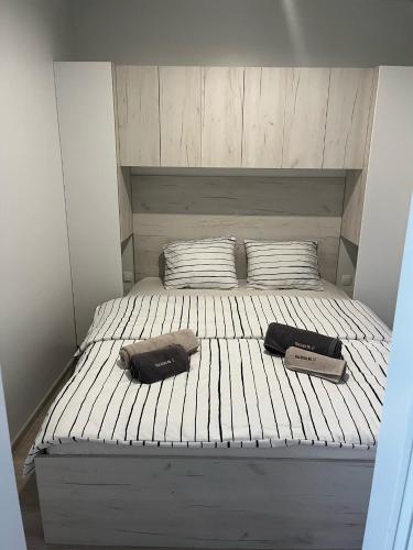a bed with two bags sitting on top of it at Vila Olson - Holiday Village Twins in Pakoštane