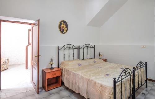 1 dormitorio con cama, mesa de madera y puerta en Beautiful Home In Bova Marina With 1 Bedrooms, en Bova Marina