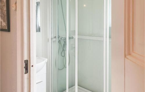 a bathroom with a shower with a glass door at Beautiful Home In Sjernary With House Sea View in Nedstrand
