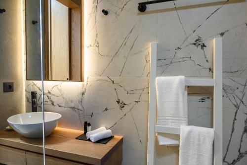 a bathroom with a sink and a counter with a mirror at Amare Studios in Agios Nikolaos