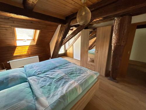 a bedroom with a bed in a room with wooden walls at Altstadtliebe in Bad Säckingen