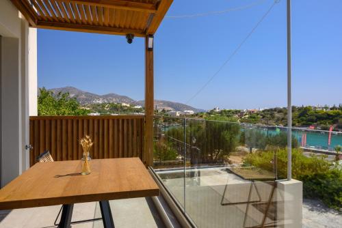 a dining room with a table and a large glass window at Amare Studios in Agios Nikolaos