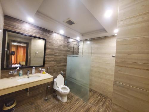 a bathroom with a toilet and a sink and a shower at Private 1-Bedroom Apartment in Rawalpindi