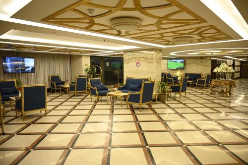 a lobby with chairs and a waiting room at Aster Hotel in Jeddah