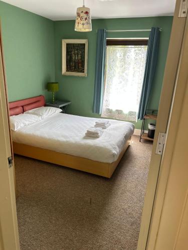 a bedroom with a bed and a window at Modern 4 Bedroom House Ring of Kerry -Killarney in Killarney