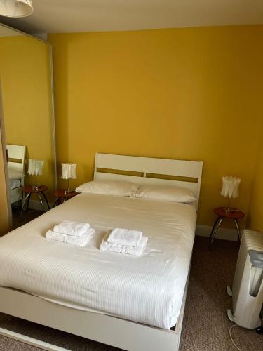 a bedroom with a white bed with two towels on it at Modern 4 Bedroom House Ring of Kerry -Killarney in Killarney